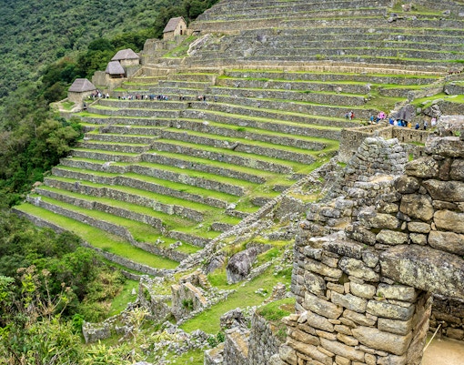 Terraced fields and agricultural area at Machu Picchu, Peru, showcasing ancient Incan farming techniques.