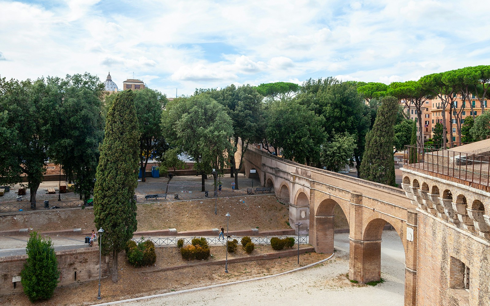 Passetto di Borgo walkway in Rome with trees and historic arches.