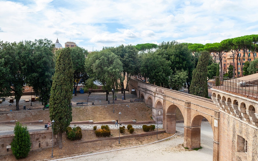 Passetto di Borgo walkway in Rome with trees and historic arches.