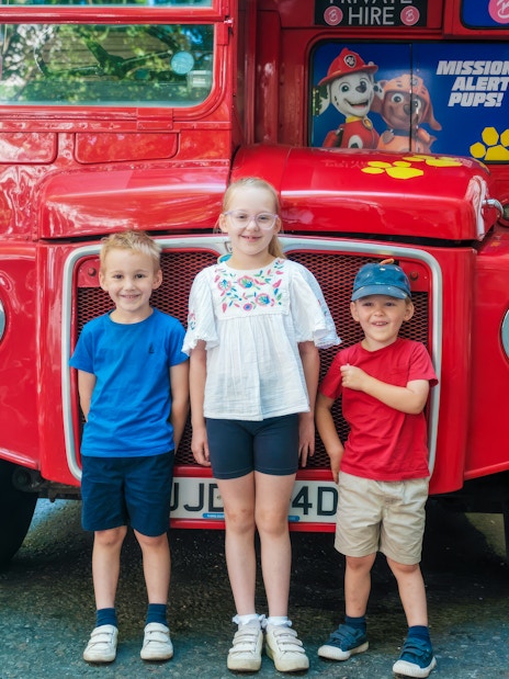 Children standing in front of Paw Patrol themed Brigit’s Afternoon Tea Bus in city street.