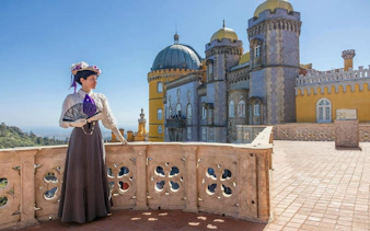 Person in period costume on Pena Palace terrace, Sintra, Portugal.