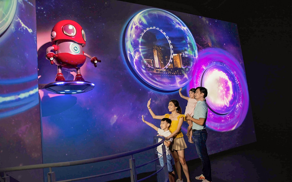Family enjoying interactive exhibit at Singapore Flyer Time Capsule.