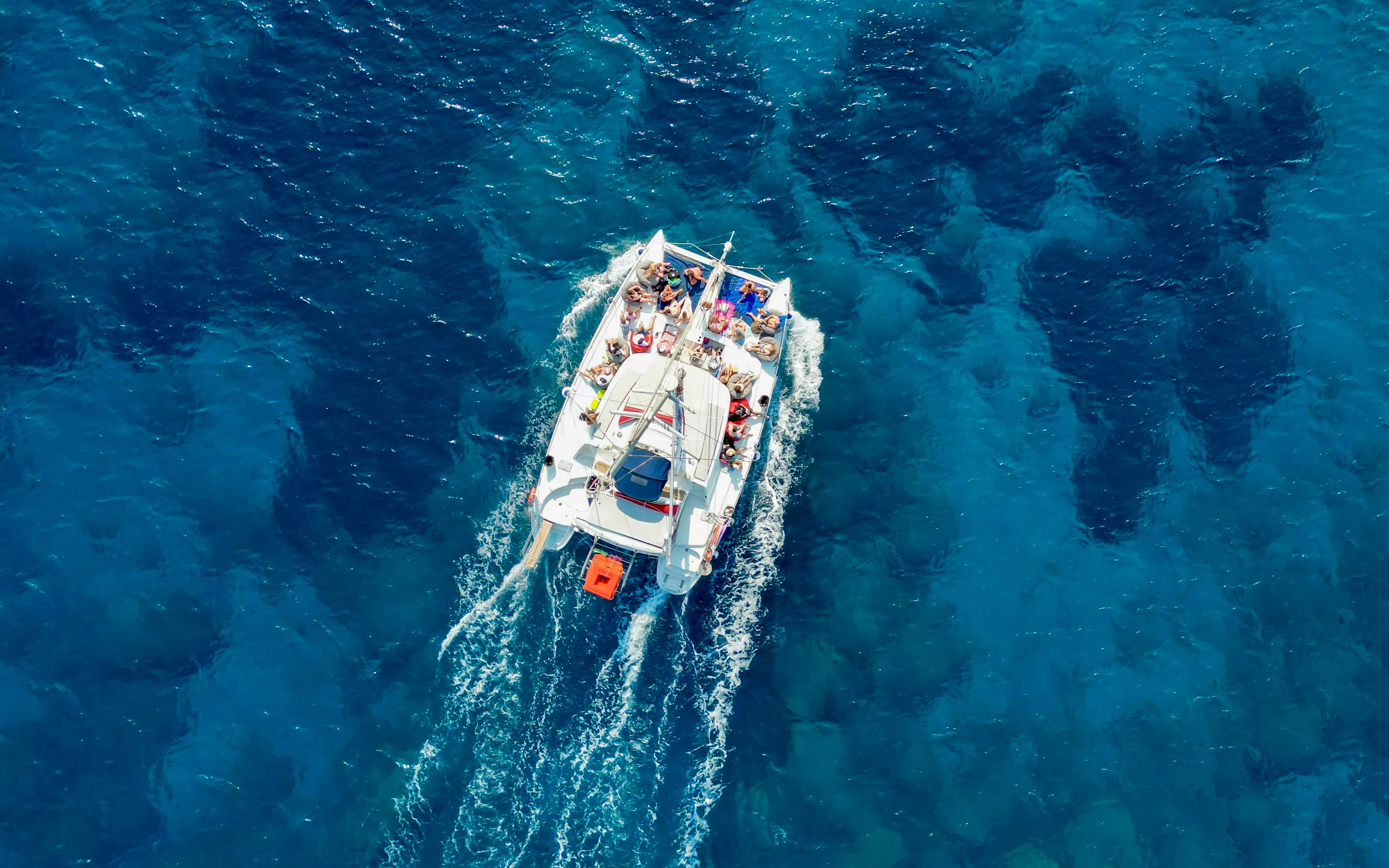 Catamaran sailing on clear blue waters, Rhodes.