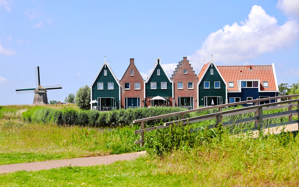 Traditional houses and windmill at Marinapark, Volendam, Netherlands.