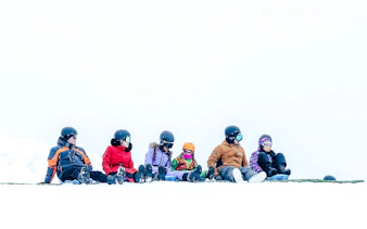 Group of people sitting in snow gear at Valle Nevado, Santiago.