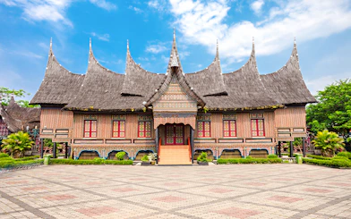 Traditional Indonesian house with ornate roof at Taman Mini Indonesia.