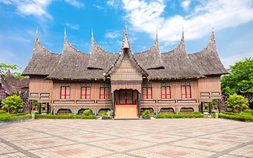 Traditional Indonesian house with ornate roof at Taman Mini Indonesia.