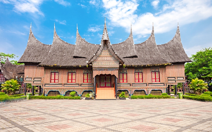 Traditional Indonesian house with ornate roof at Taman Mini Indonesia.