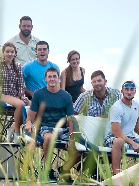 Group enjoying an Everglades airboat ride through marshland.