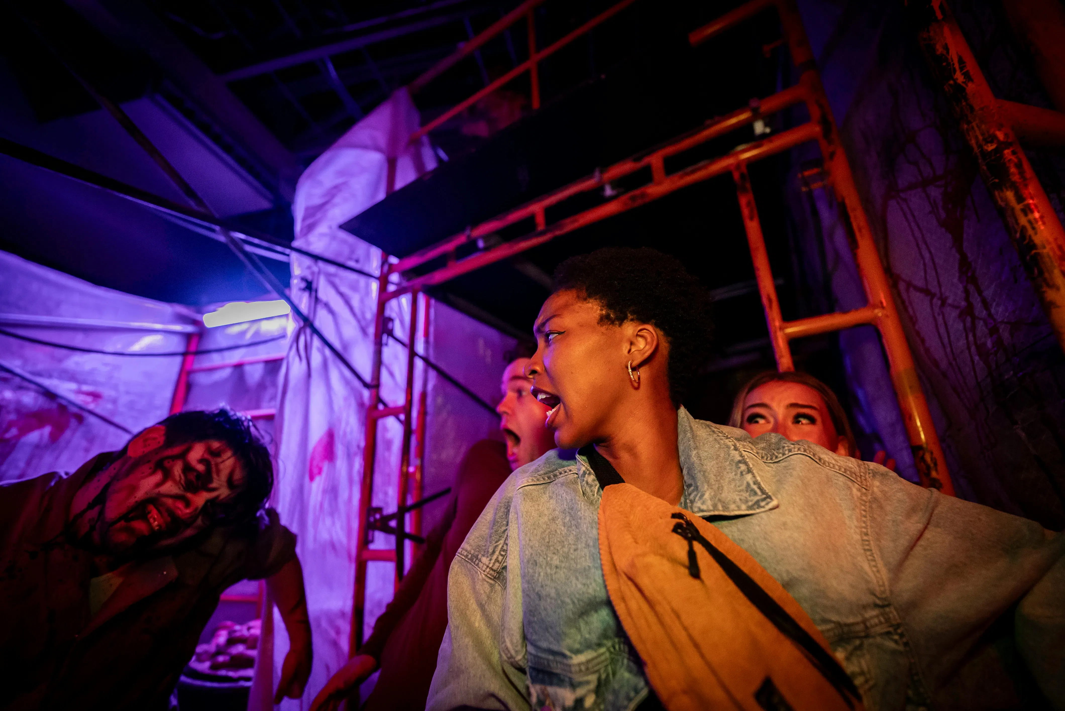 Visitors react to a zombie actor at Canada's Wonderland Halloween Haunt.