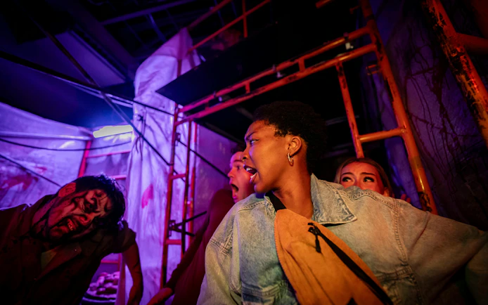 Visitors react to a zombie actor at Canada's Wonderland Halloween Haunt.