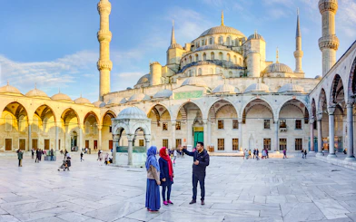 Visitors exploring the courtyard of the Blue Mosque in Istanbul, Turkey.