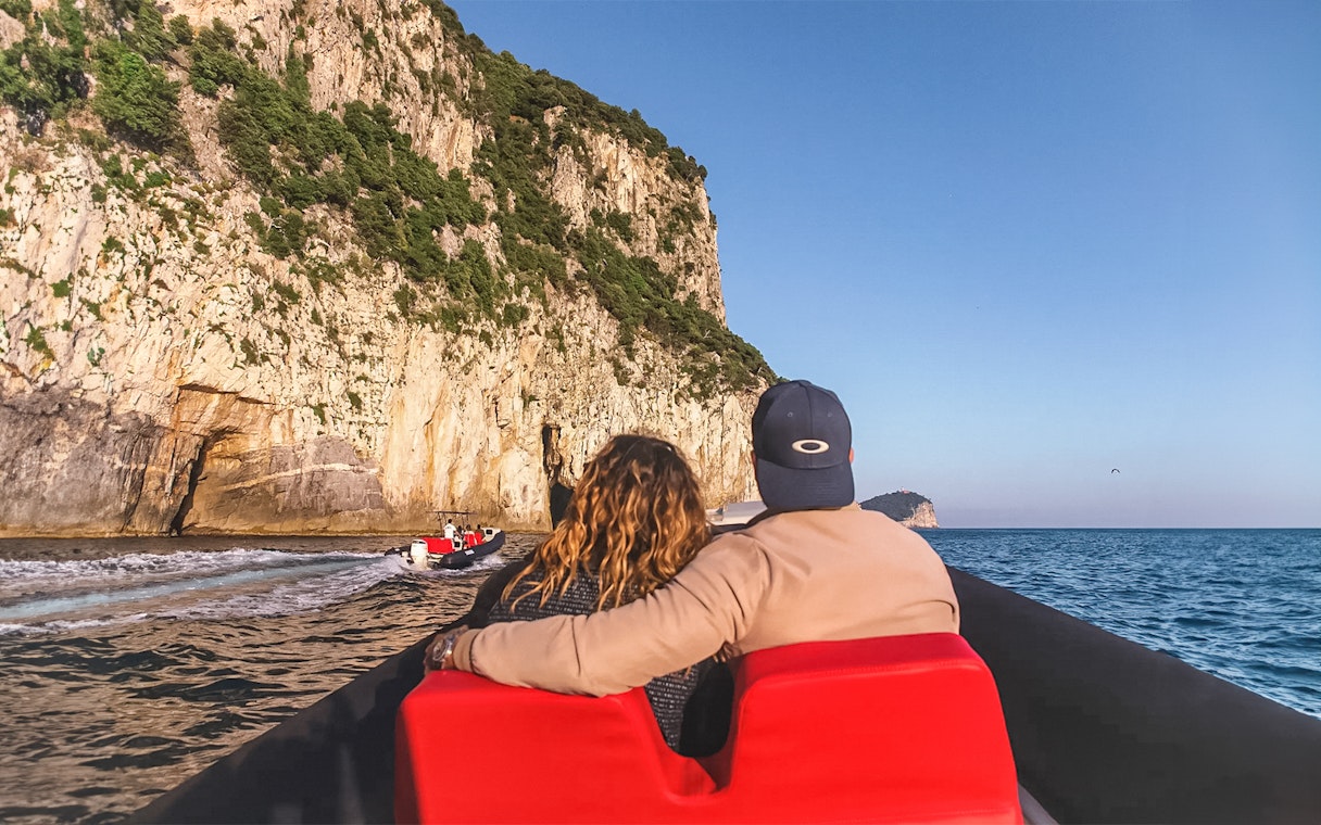Couple on boat tour near cliffs in Cinque Terre, Italy, departing from La Spezia.