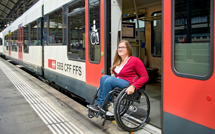 Train with wheelchair access at Geneva station platform.