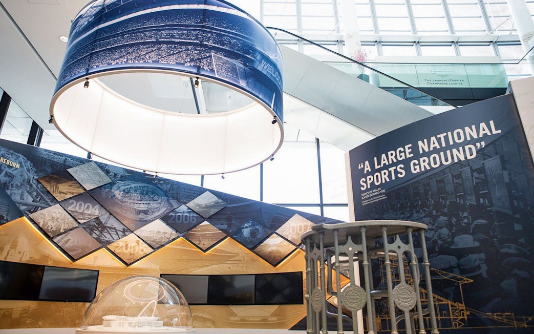 Wembley Stadium interior exhibit with historical timeline and sports memorabilia.