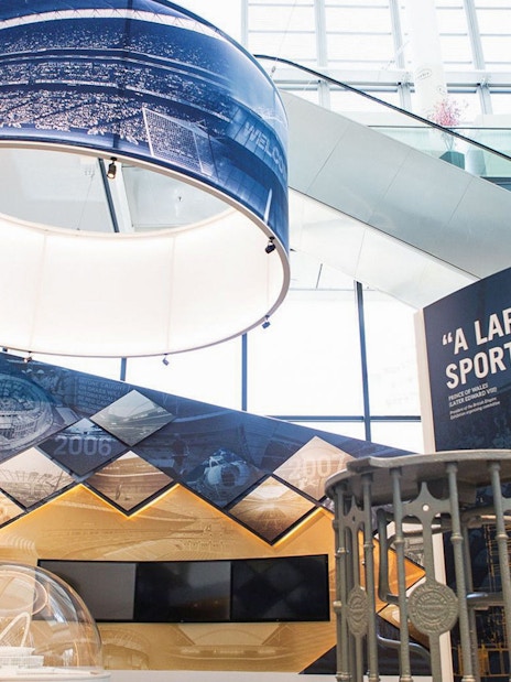 Wembley Stadium interior exhibit with historical timeline and sports memorabilia.