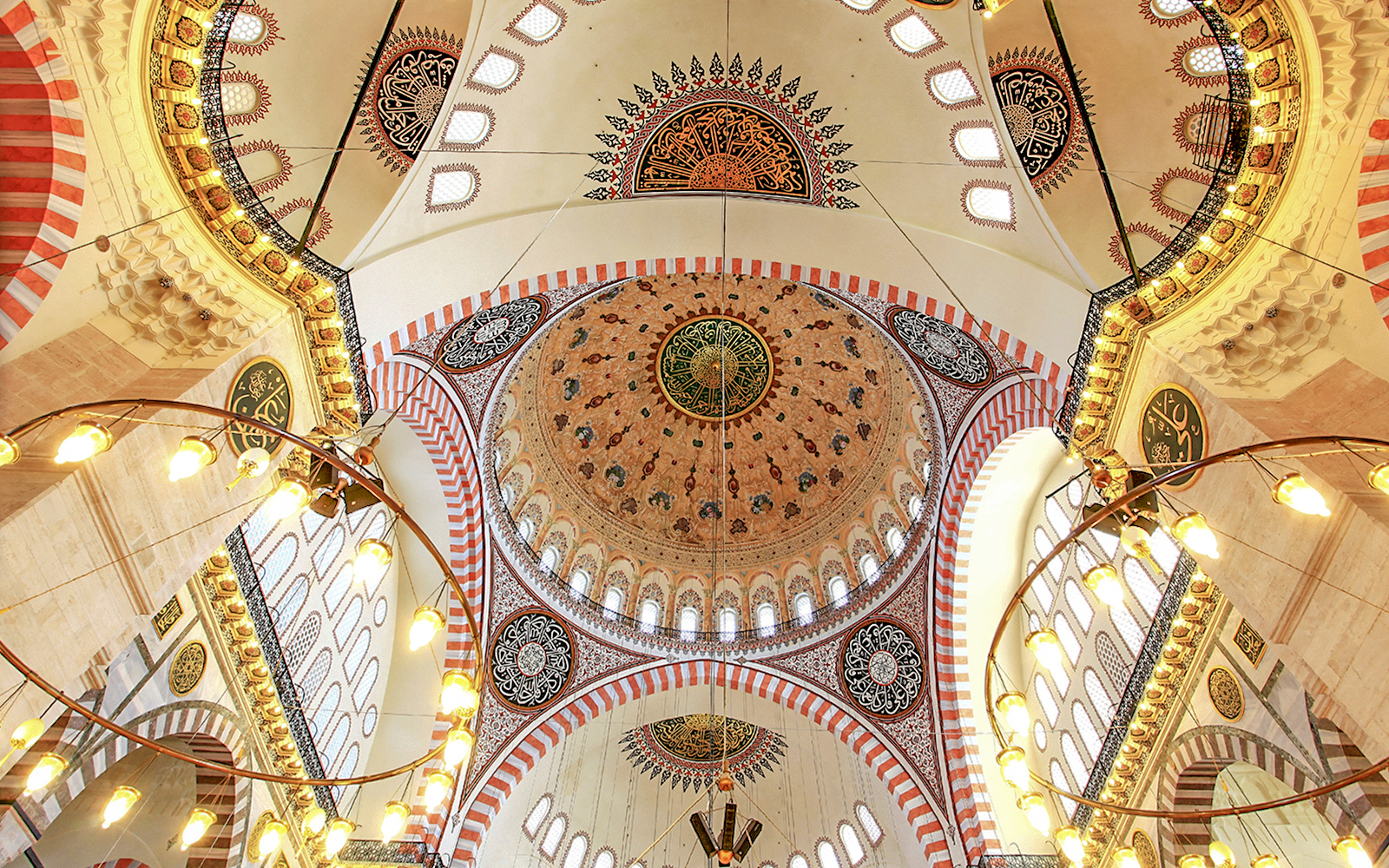 Interior view of the Suleymaniye Mosque dome with intricate patterns and calligraphy, Istanbul.