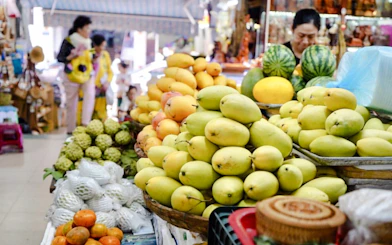 Fruit market stall with mangoes and other tropical fruits in Da Nang.