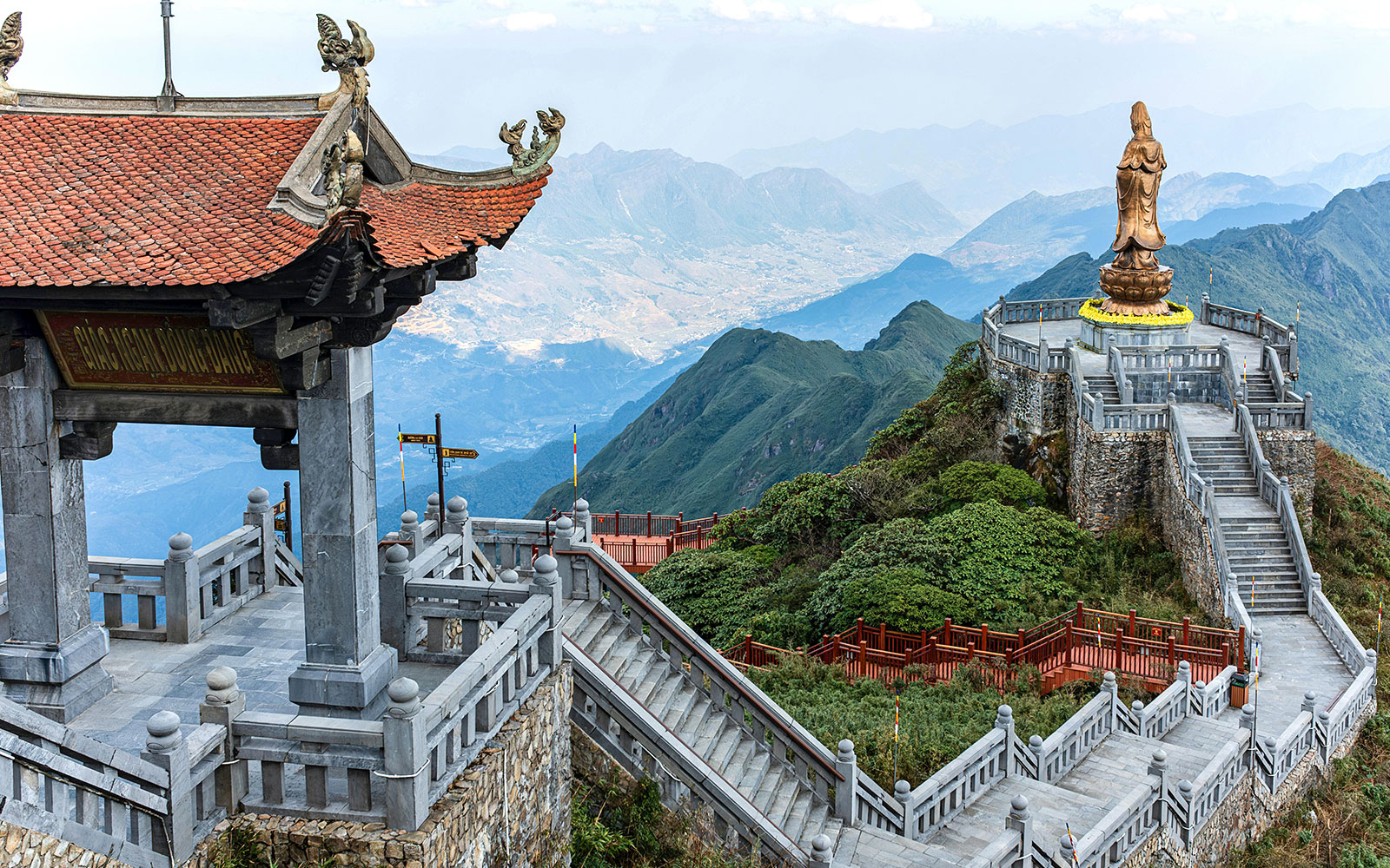 Terraced steps leading to a statue at Sun World Fansipan Legend, Vietnam, with mountain views.