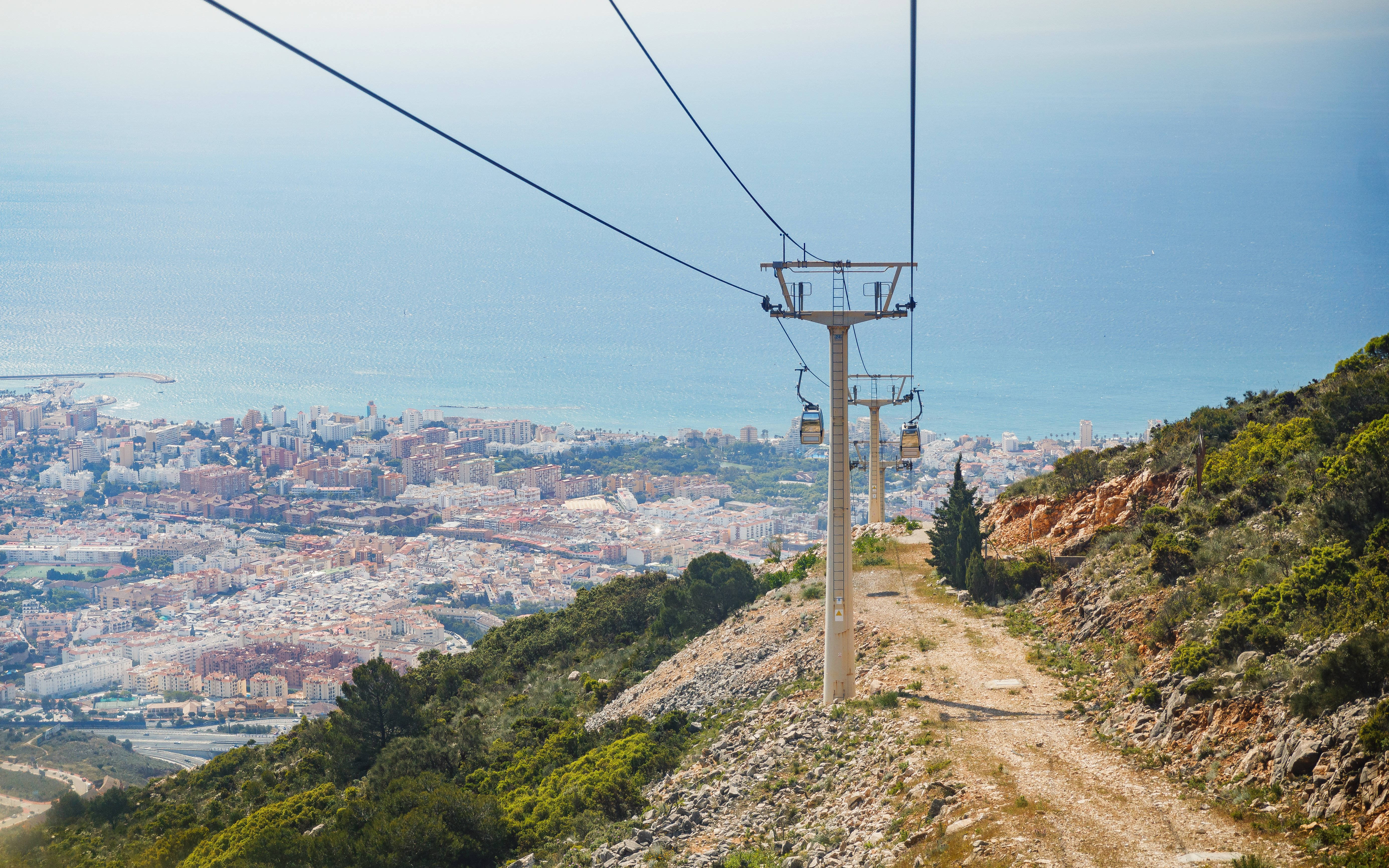 Benalmádena Cable Car ascending with city and sea view in the background.