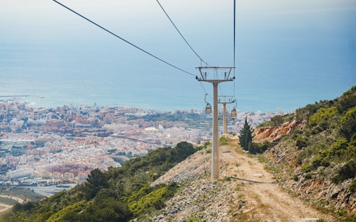 Benalmádena Cable Car ascending with city and sea view in the background.