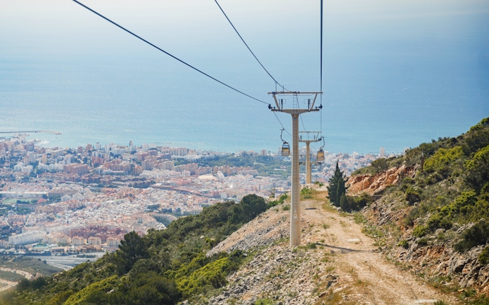Benalmádena Cable Car ascending with city and sea view in the background.