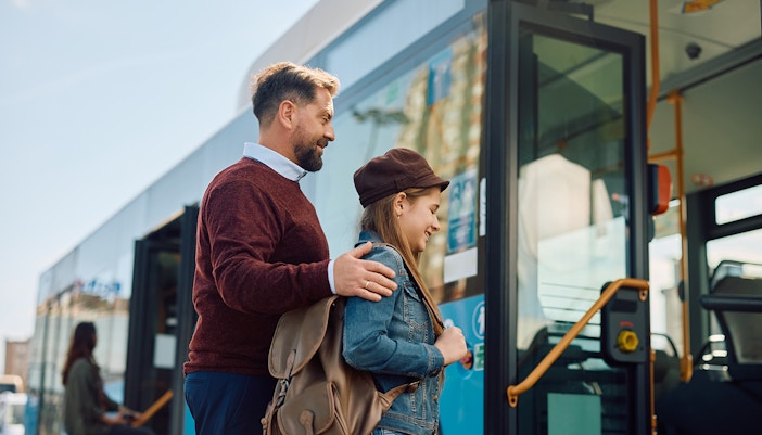Tourist family boarding a bus for a city tour.