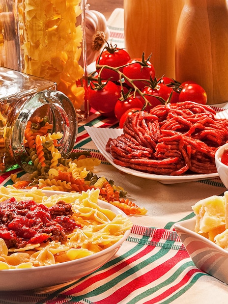 Italian pasta with tomato sauce and cheese on a table in Rome.