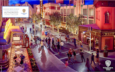Visitors at Warner Bros. World Abu Dhabi interacting with costumed characters on a themed street.