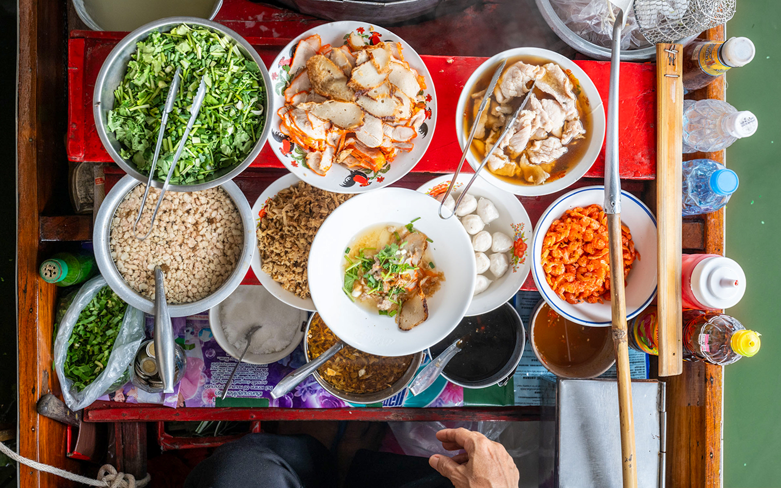 Assorted Thai dishes on a boat at Damnoen Saduak Floating Market.