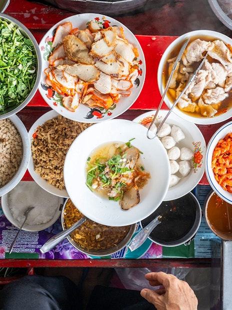 Assorted Thai dishes on a boat at Damnoen Saduak Floating Market.