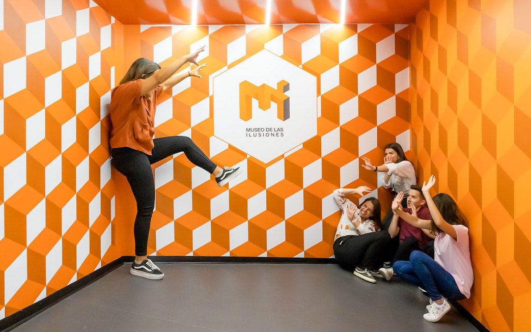 Group interacting with optical illusion at Museo de las Ilusiones Sevilla.
