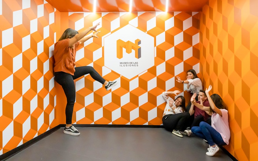 Group interacting with optical illusion at Museo de las Ilusiones Sevilla.