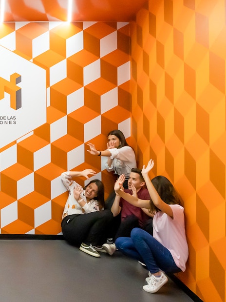 Group interacting with optical illusion at Museo de las Ilusiones Sevilla.