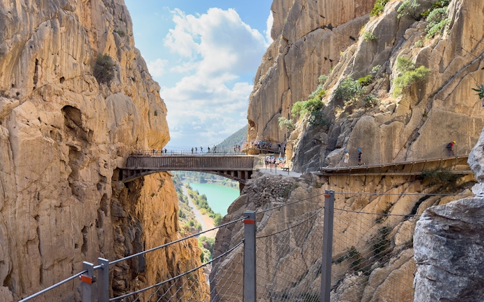 Caminito del Rey walkway between cliffs with tourists, near Granada and Seville, Spain.