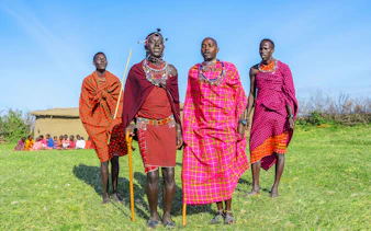 Maasai men performing traditional jumping dance in Maasai Mara, Kenya.