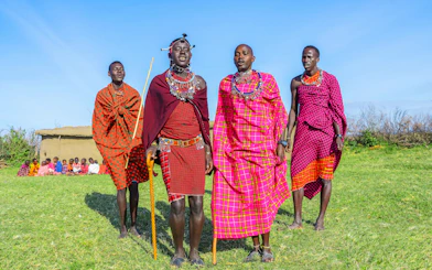 Maasai men performing traditional jumping dance in Maasai Mara, Kenya.