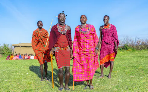 Maasai men performing traditional jumping dance in Maasai Mara, Kenya.