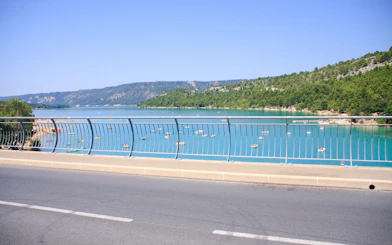 Croix lake view from Galetas bridge with boats on turquoise water.