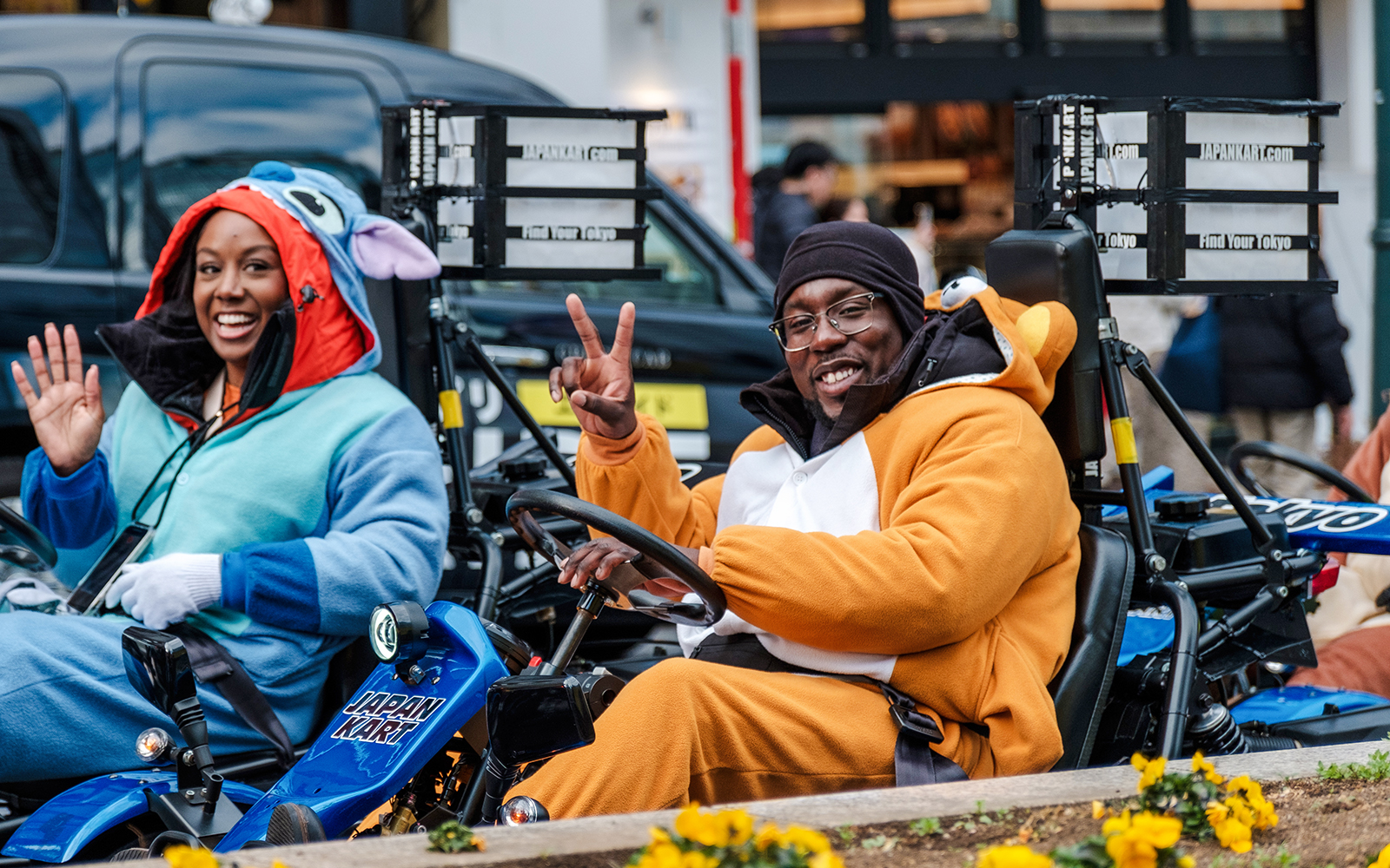 Go-kart riders in costumes enjoying Shibuya, Tokyo tour.