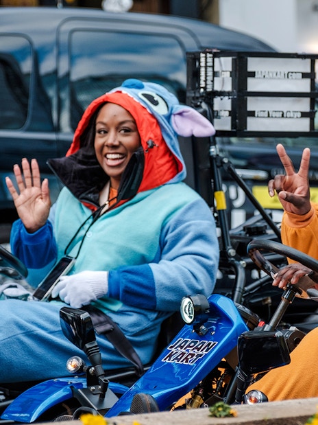 Go-kart riders in costumes enjoying Shibuya, Tokyo tour.