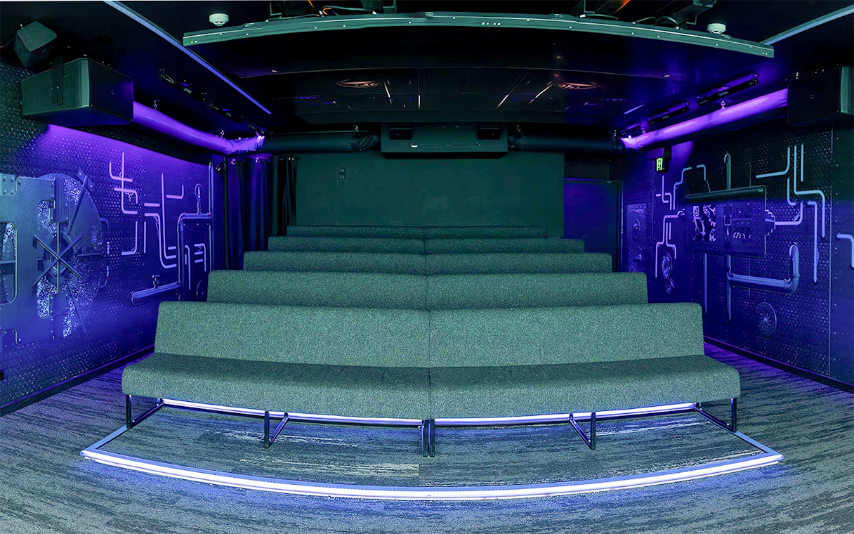 Underwater-themed theatre seating with neon lighting.
