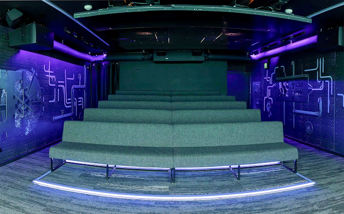 Underwater-themed theatre seating with neon lighting.