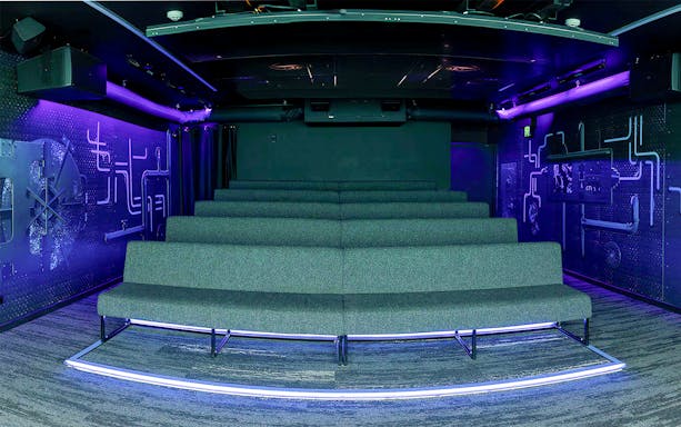 Underwater-themed theatre seating with neon lighting.