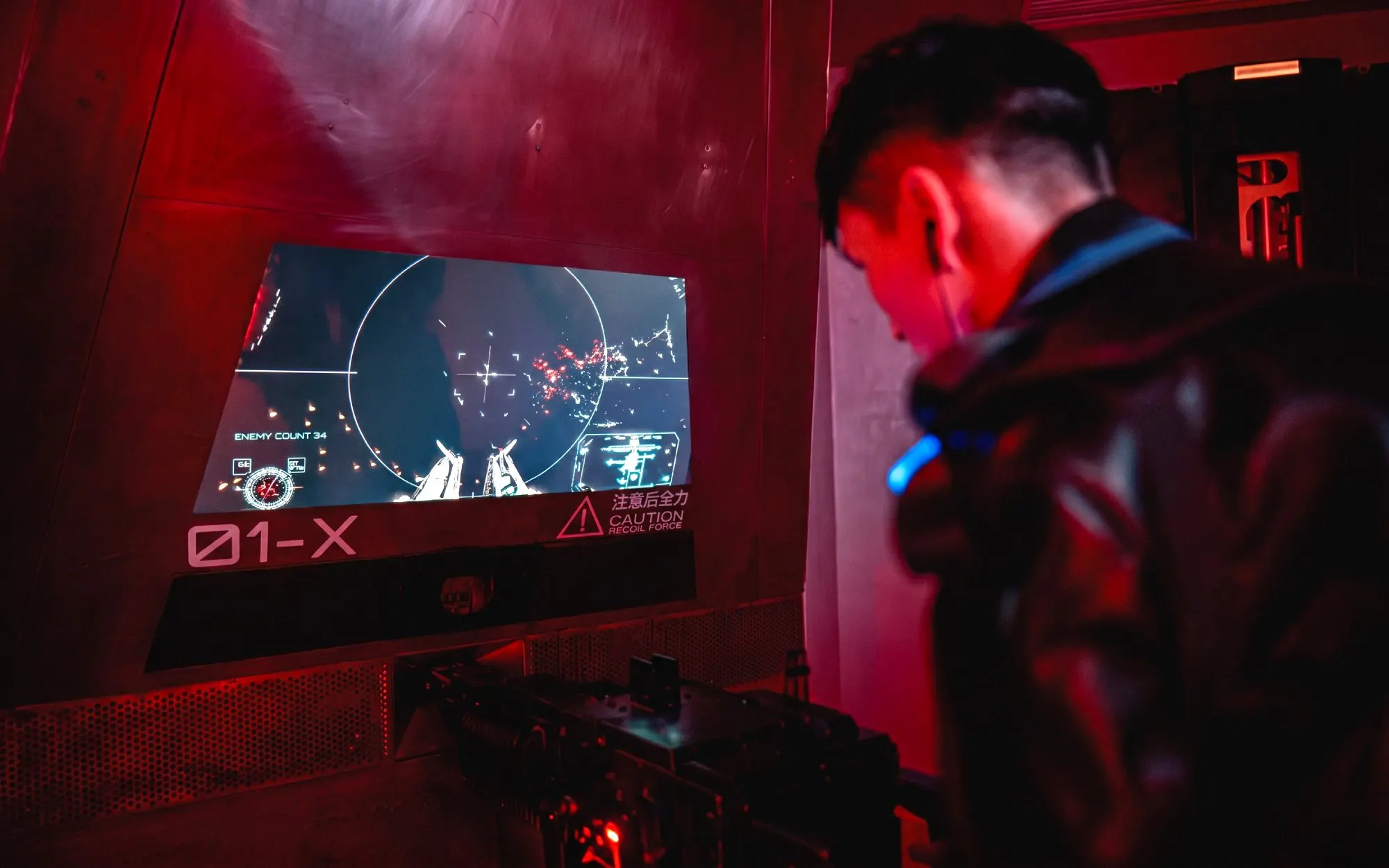 Person interacting with a futuristic control panel at AI Dream Immersive Theater.