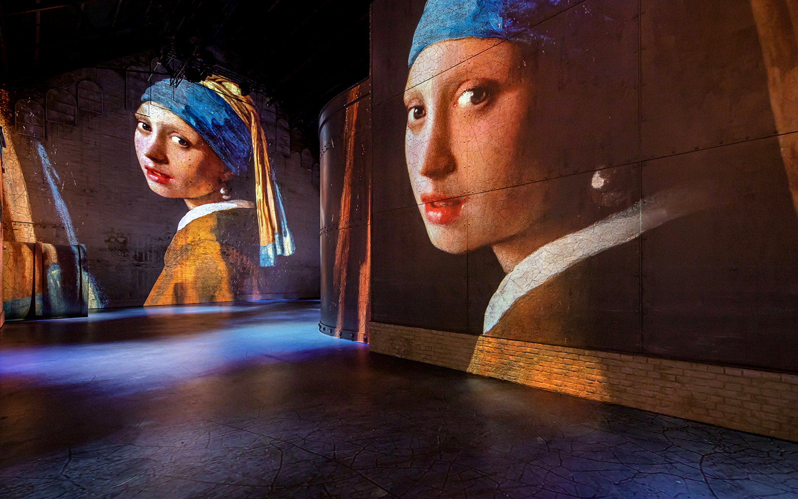 Projections of Vermeer's "Girl with a Pearl Earring" at Fabrique des Lumières exhibition.