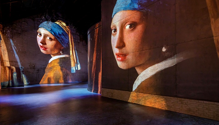 Projections of Vermeer's "Girl with a Pearl Earring" at Fabrique des Lumières exhibition.