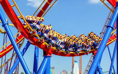 Visitors riding a colorful roller coaster at Parque Warner Madrid.