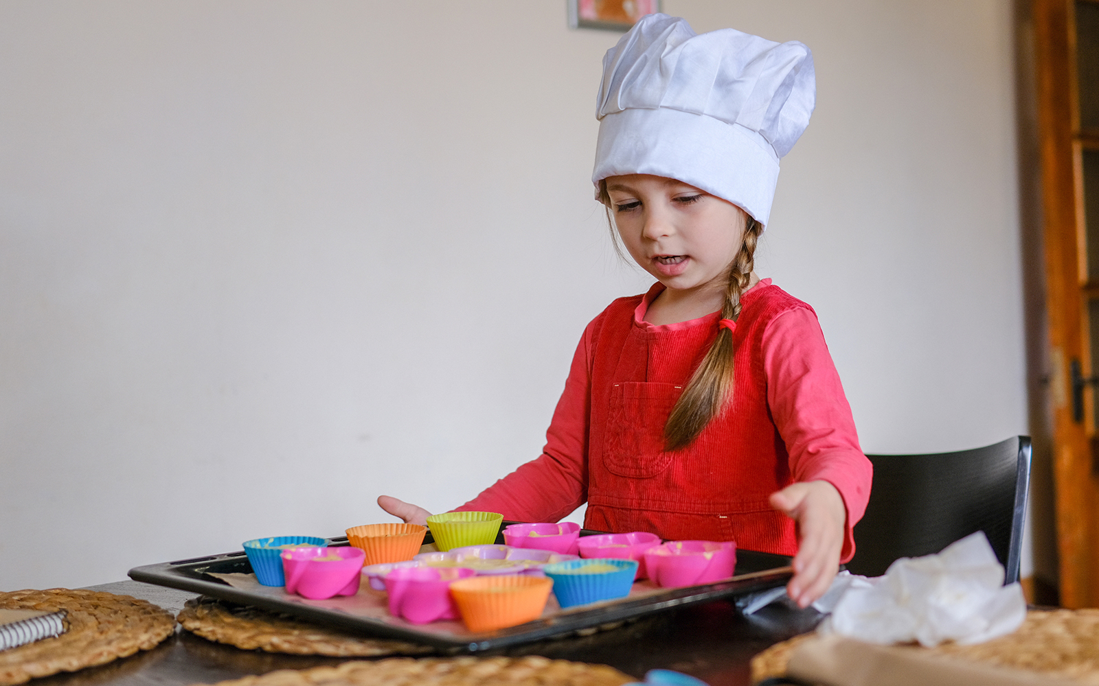 Child engaging in a cooking activity in a modern kitchen setting.