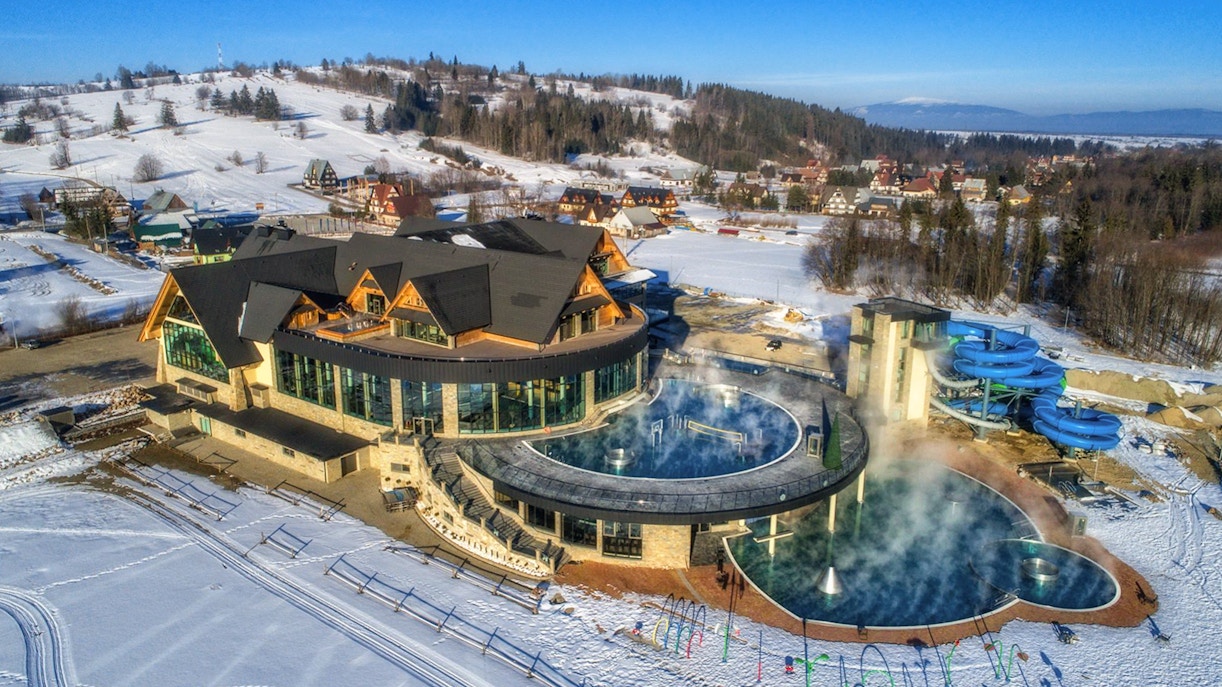 Chocholow Thermal Baths with snow-covered landscape and water slides in Poland.